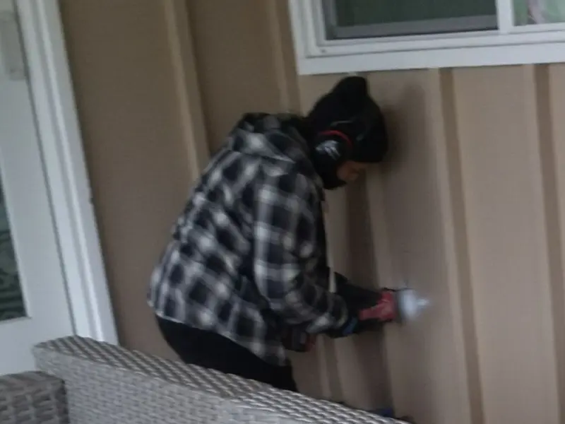 Professional electrician installing an exterior outlet in Brookhaven